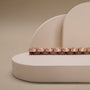 "Duet" keyboard with a walnut and rose gold finish, showcasing a sleek and elegant design.