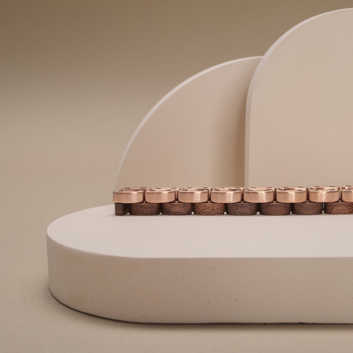 "Duet" keyboard with a walnut and rose gold finish, showcasing a sleek and elegant design.
