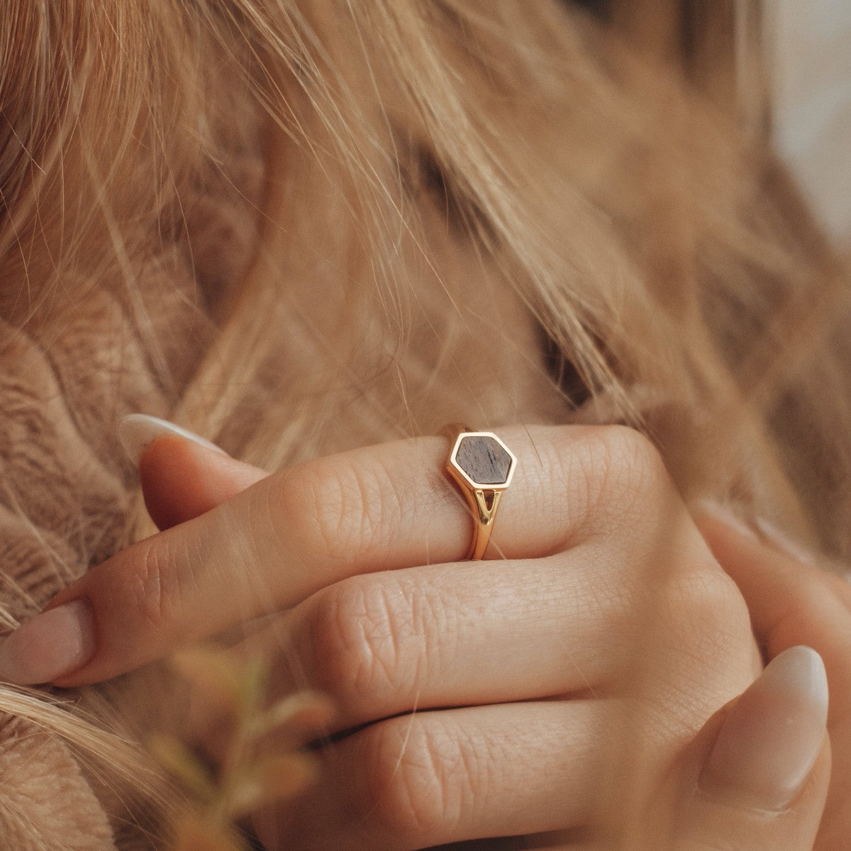 "Facade Ring": A modern hexagonal ring featuring a walnut inlay set in gold.
