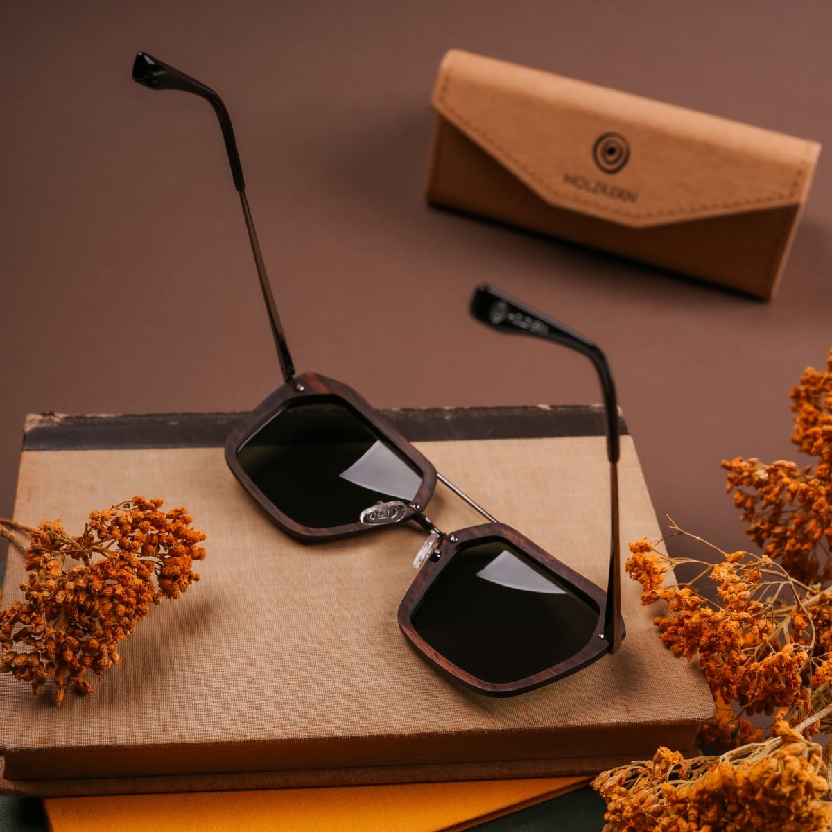"The Storyteller sunglasses featuring a Leadwood frame and Antique Silver accents, styled with elegant charm."
