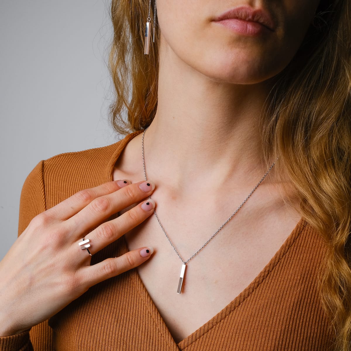 "Campania Necklace" necklace in walnut and silver, featuring a sleek rectangular pendant design for a modern look.