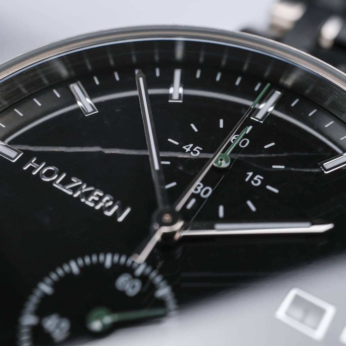 "The Observant watch featuring a sleek maple and marble design with a modern aesthetic."