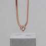 "Awakening Necklace", a rose gold necklace with a modern, geometric design.