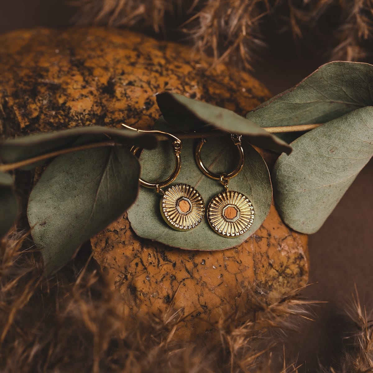 "Stencil Earrings", round earrings with koa wood and gold accents, featuring a textured, natural style.