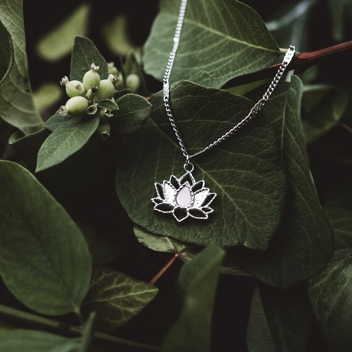 "Balance Necklace" - a delicate marble and silver necklace with a balanced, natural style against lush greenery.