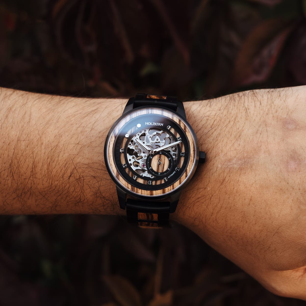 "Sternum" watch featuring zebrawood and black accents in an elegant, mechanical design.
