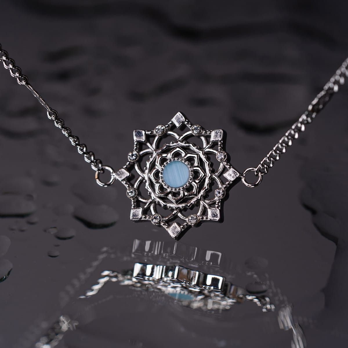 "Aphonia Bracelet" bracelet, featuring ornate silver design with aquamarine centerpiece, reflecting a sophisticated style.