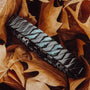 "Baritone" bracelet in marble and black, featuring a sleek, modern design amidst autumn leaves.