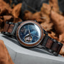 "Alrakis" watch features a striking walnut and marble design with an elegant, sophisticated style.