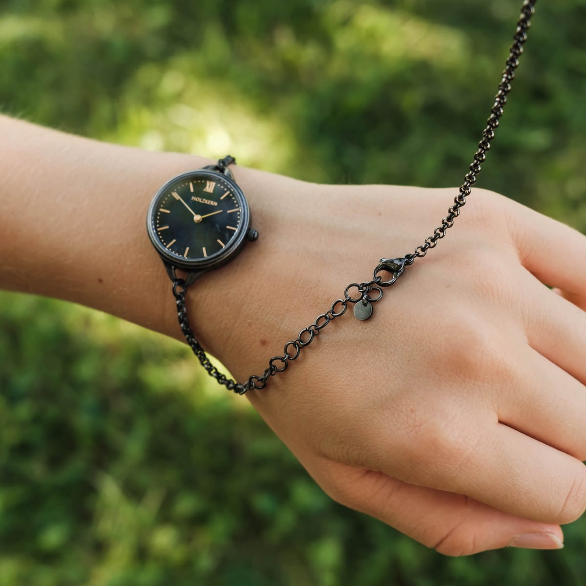 "Bracelet fastening tool", a sleek bracelet fastening tool, shown in gray with a minimalist style.