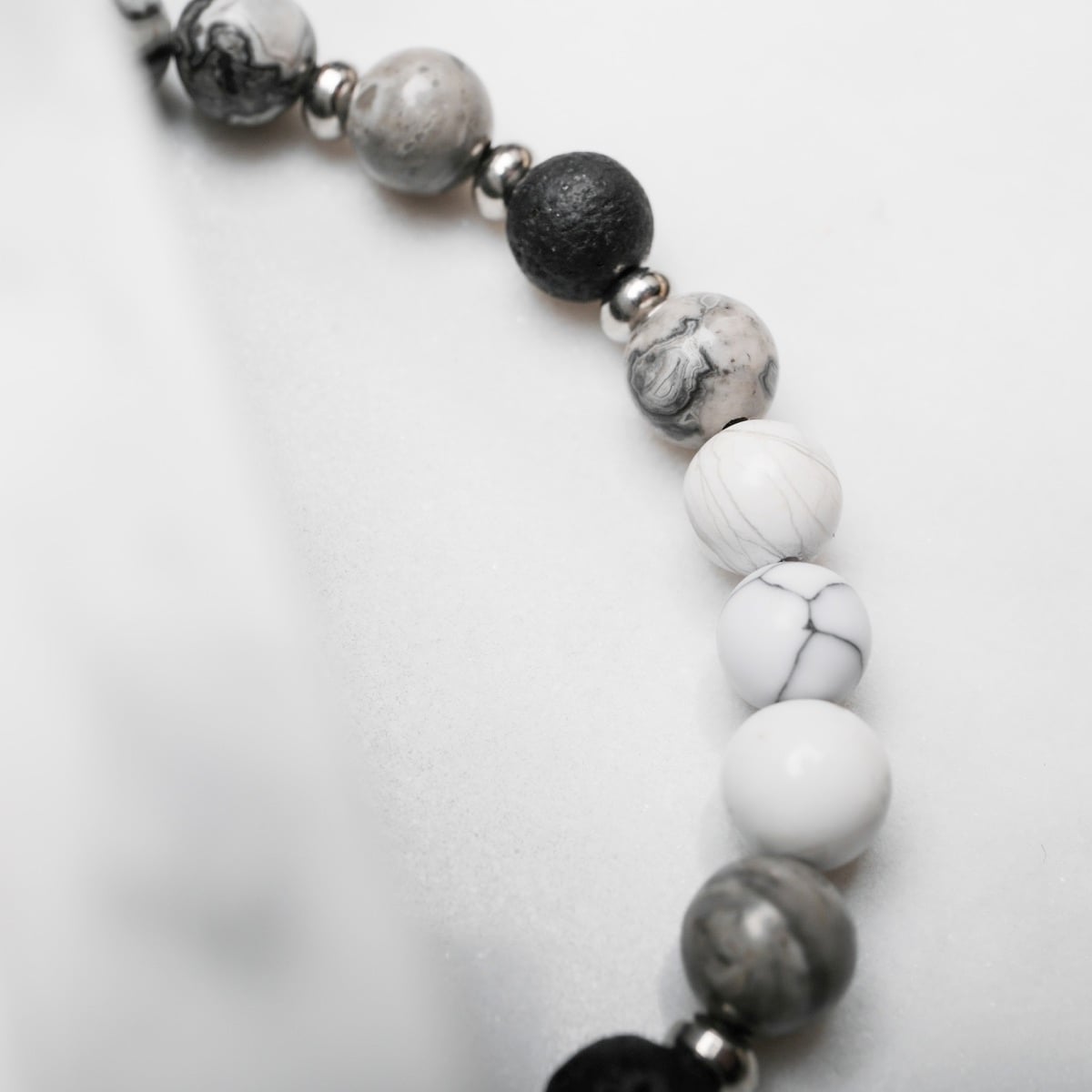 "Superset" beaded bracelet with a blend of Howlite and Picasso Jasper, showcasing an elegant marble-like pattern.