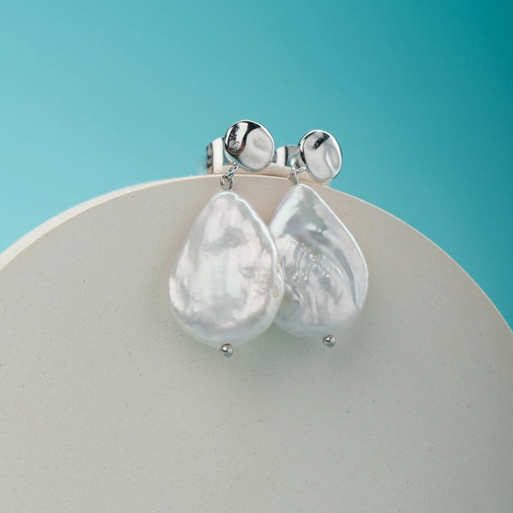 "Summersweet Earrings": Baroque pearl and silver earrings with a sleek, elegant style.