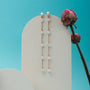 "Summersweet Earrings II": Elegant rose gold earrings adorned with pearls, styled against a vibrant backdrop.