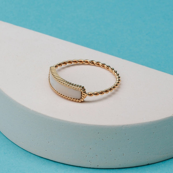 "Summersweet Ring", a gold and white nacre ring with an elegant twisted rope band.