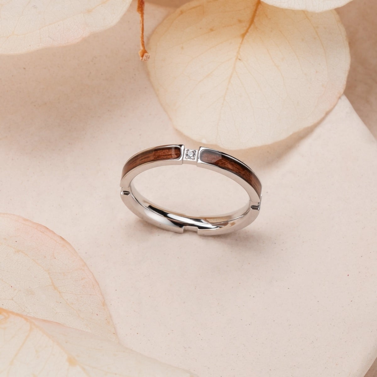 "Campania Ring II" - Elegant ring with walnut inlay and silver accents, showcasing a modern and sleek design.