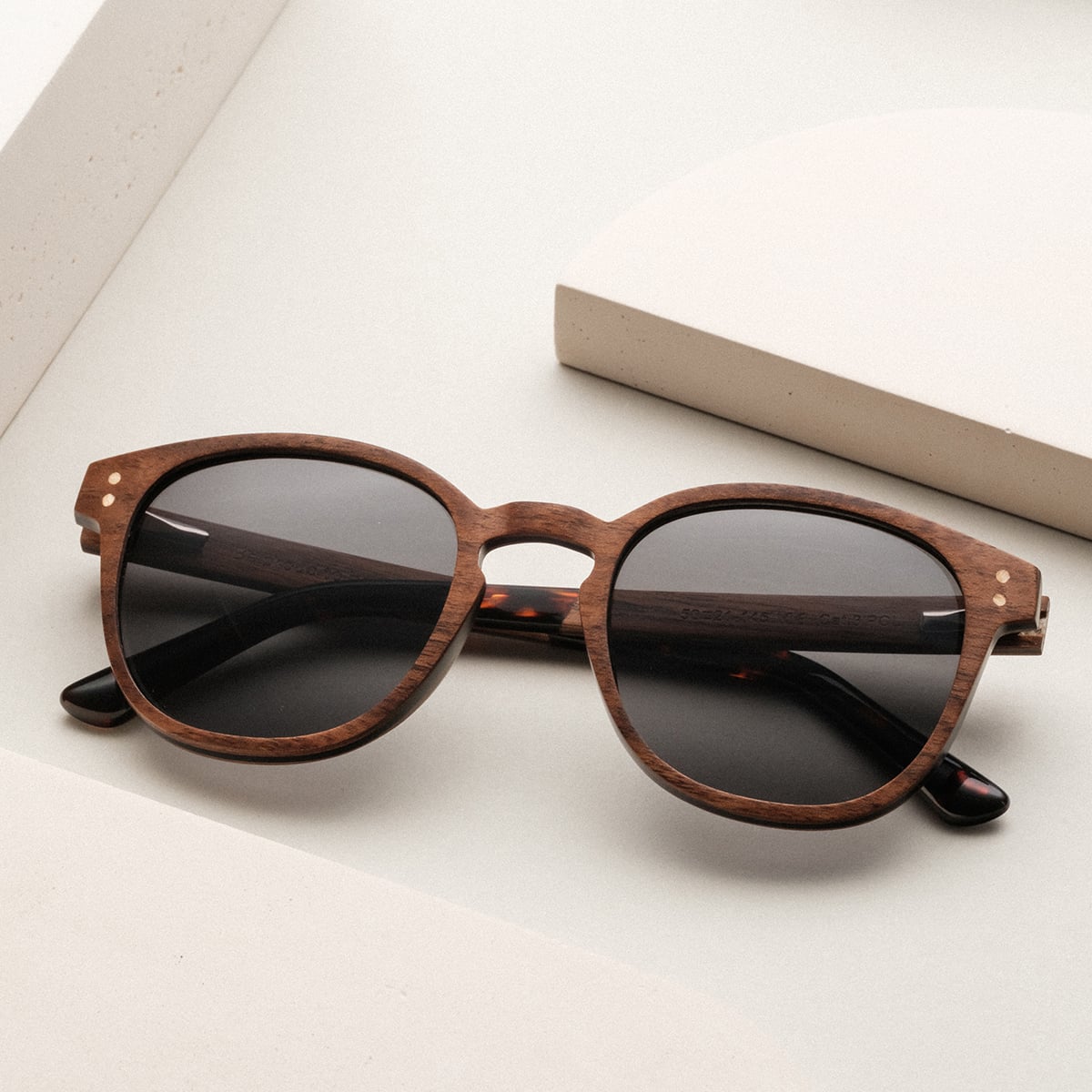 "The Humble" sunglasses in a classic walnut finish, featuring round frames and dark lenses.