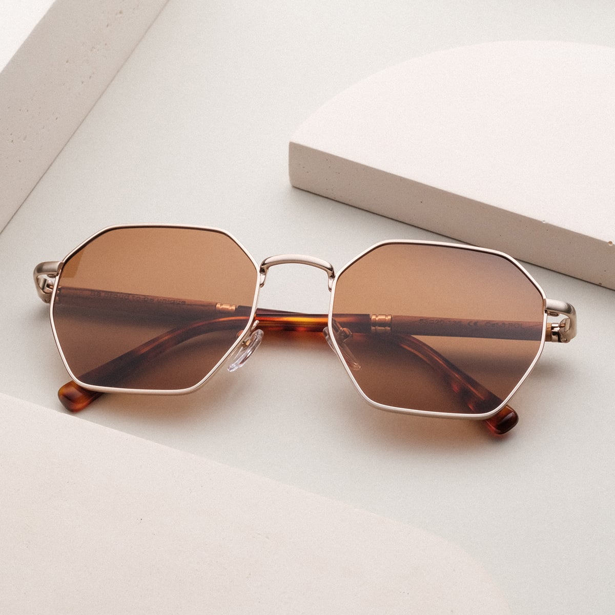 "The Magical" sunglasses featuring a stylish zebrawood and gold design with octagonal lenses.