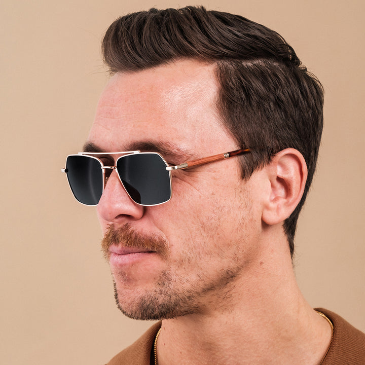 "The Professor I" sunglasses with a padauk and matte gold finish, featuring a sleek and modern square design.