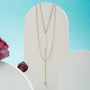 "Summersweet Necklace", an elegant necklace featuring pearls and zirconia, with a layered design and a delicate gold chain.