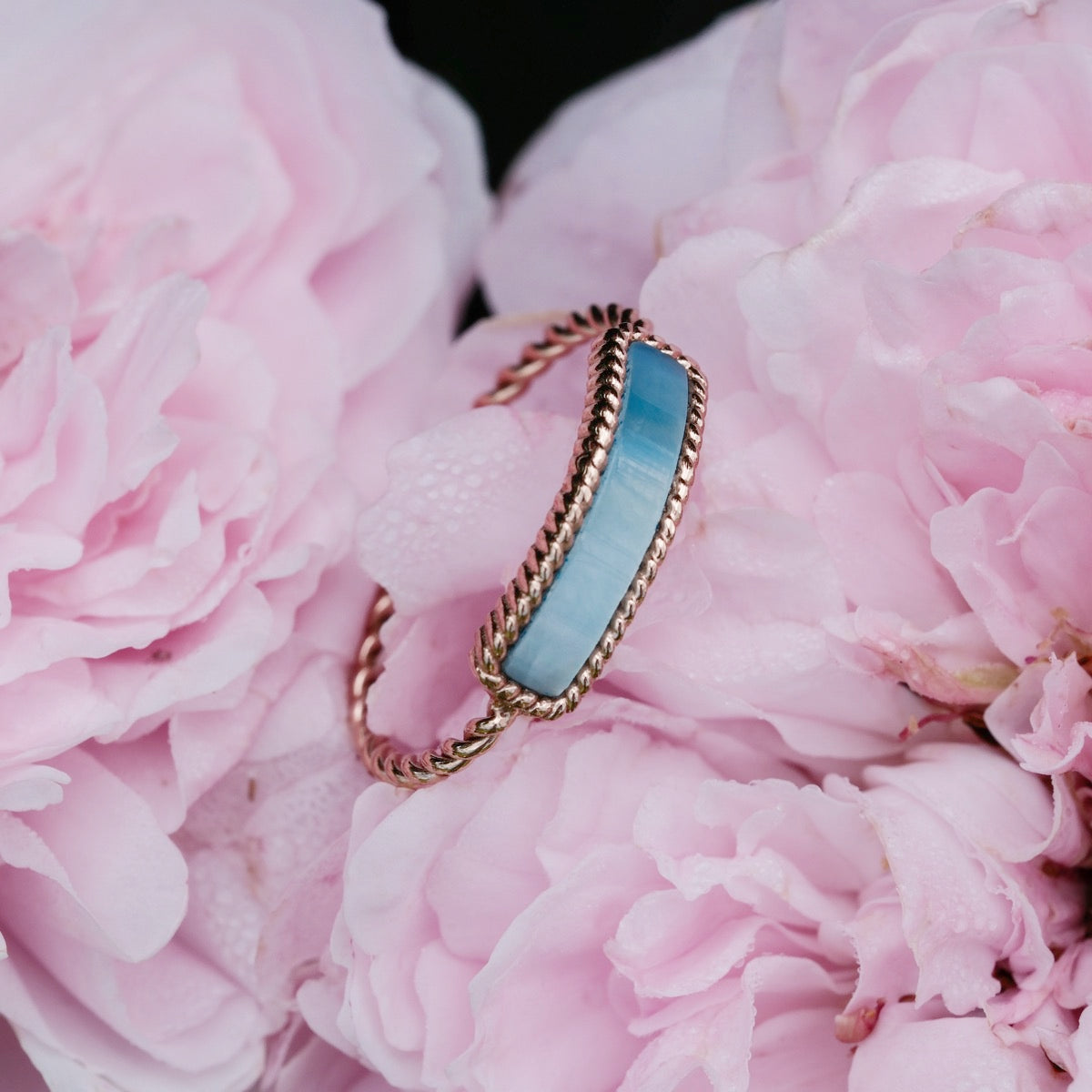 "Summersweet Ring" - Elegant ring with nacre inlay and rose gold finish, styled with delicate pink floral background.