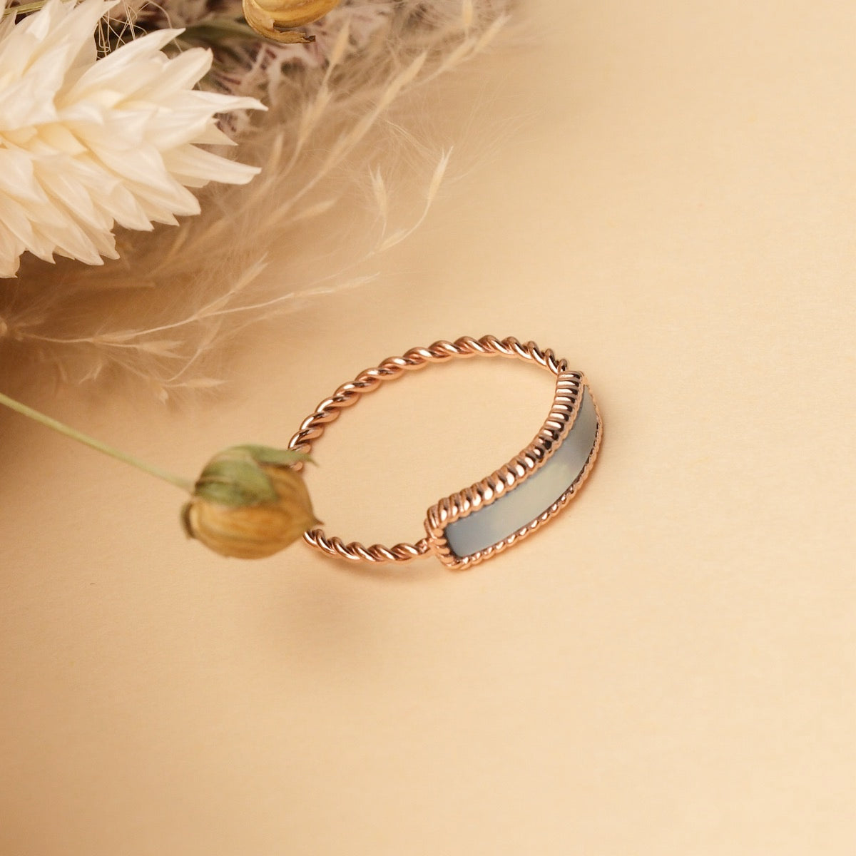 "Summersweet Ring": Stylish ring with nacre and rose gold accents, featuring a twisted design and elegant visual appeal.