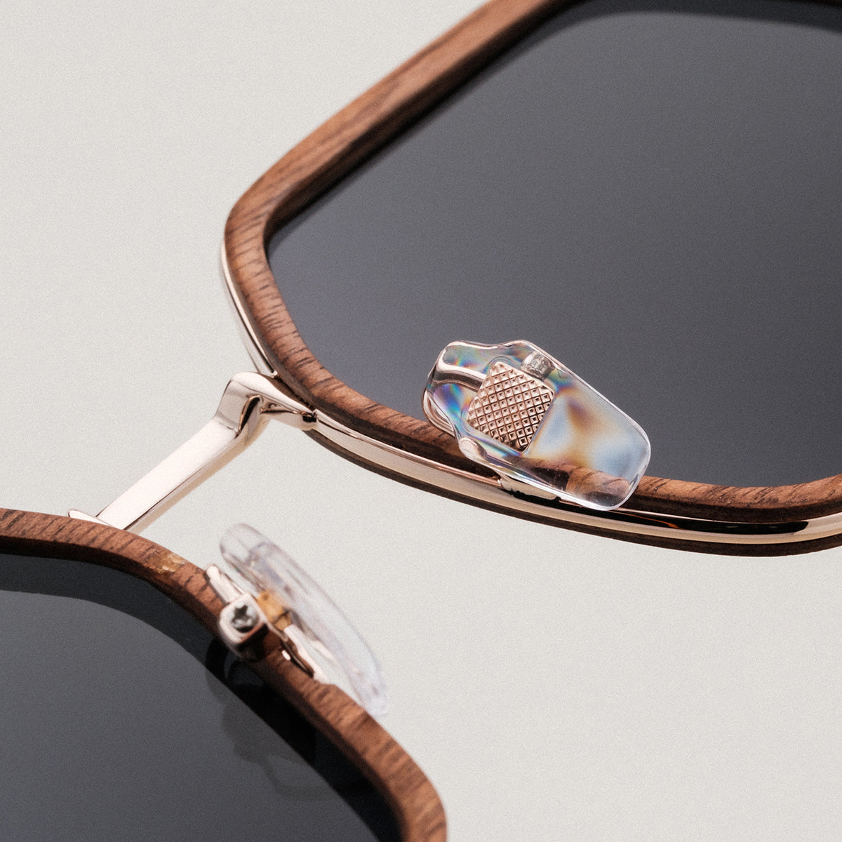 "The Sincere" sunglasses featuring a walnut frame and matte gold accents for a sophisticated look.