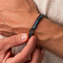 "Supersonic", a stylish bracelet with a maple and gray design, worn on the wrist.