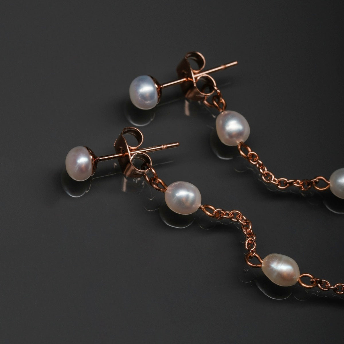 "Summersweet Earrings II": Pearl and rose gold earrings with a delicate, elegant design.