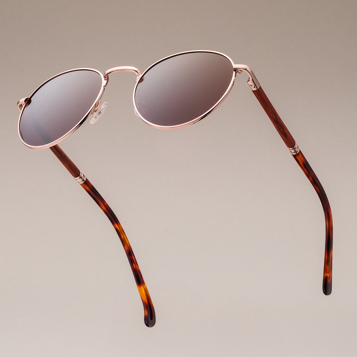 "The Achiever" sunglasses feature a padauk frame and matte gold accents for a sleek, stylish look.