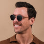 "The Magical" sunglasses featuring a zebrawood and gold design with a modern geometric style.