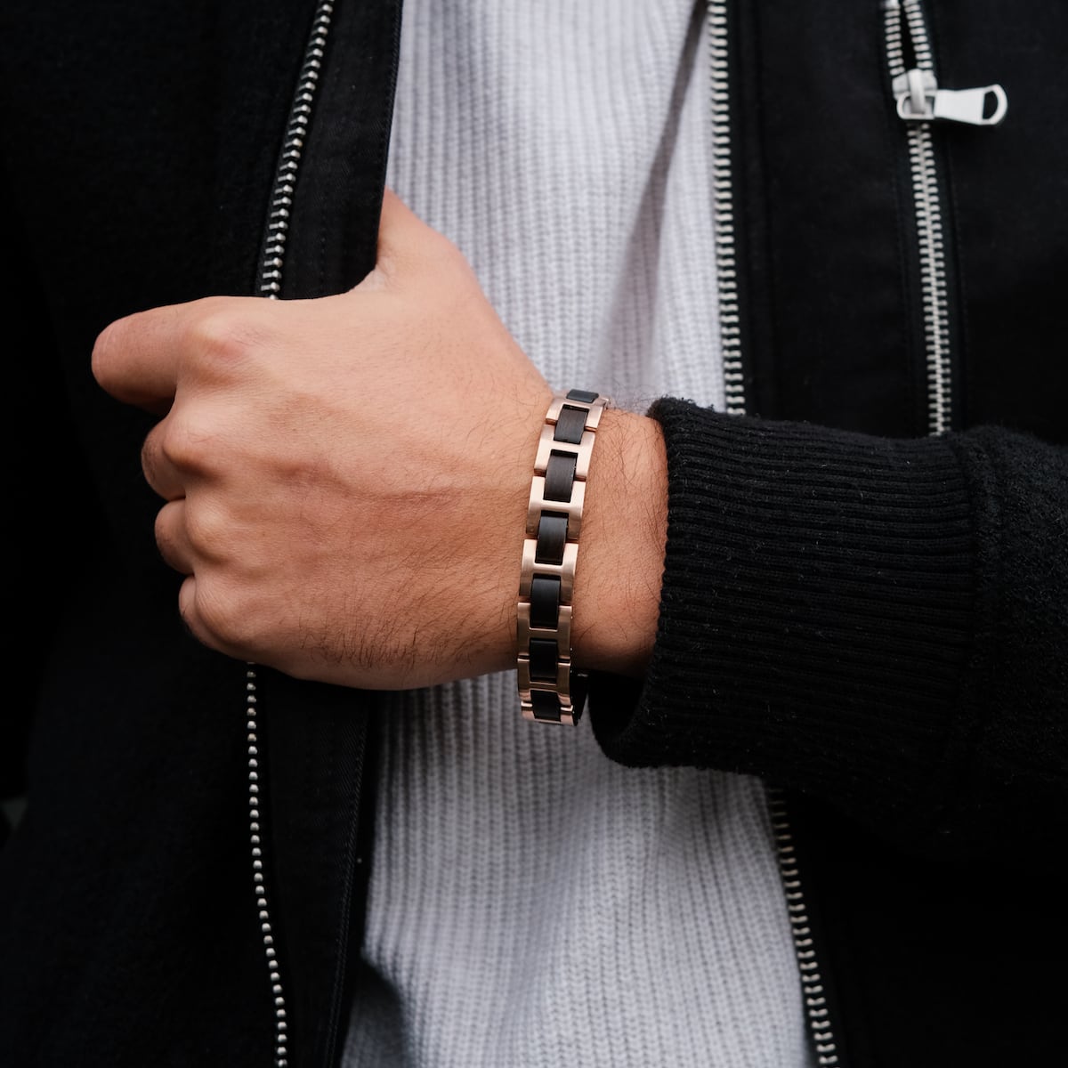 "Acoustic", a stylish bracelet featuring maple and rose gold tones, worn with a black jacket.