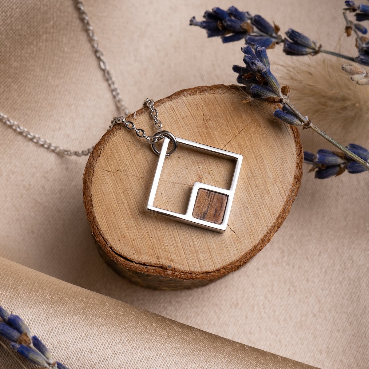 "Geometric Necklace" necklace featuring a geometric design with koa wood and silver elements.