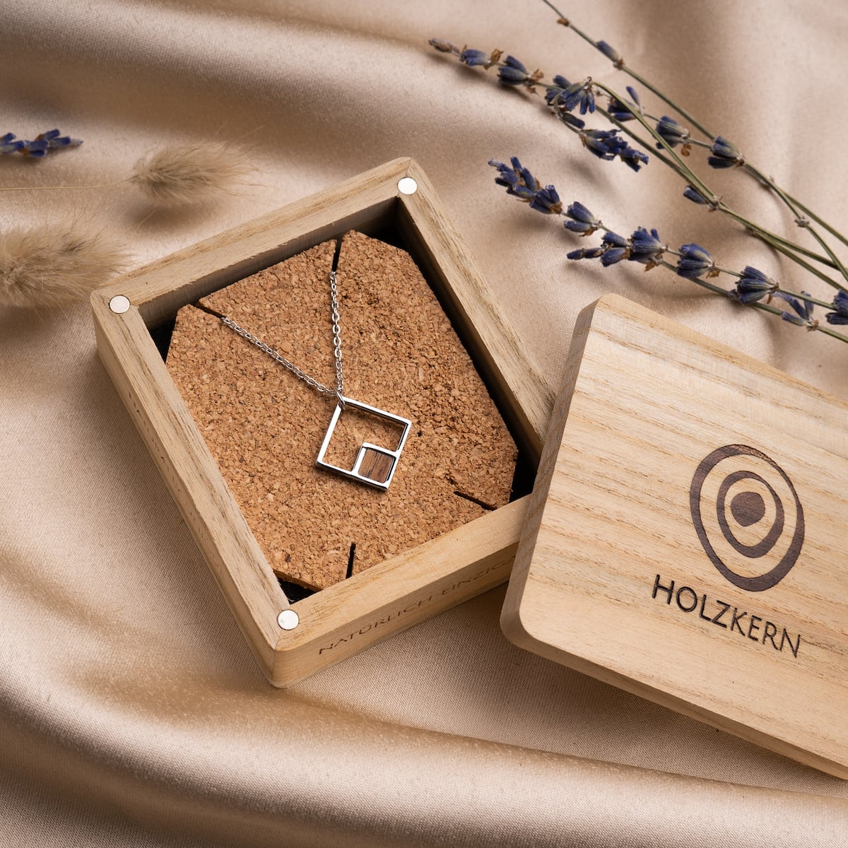 "Geometric Necklace": A geometric necklace featuring koa wood and silver in an elegant rectangular design.