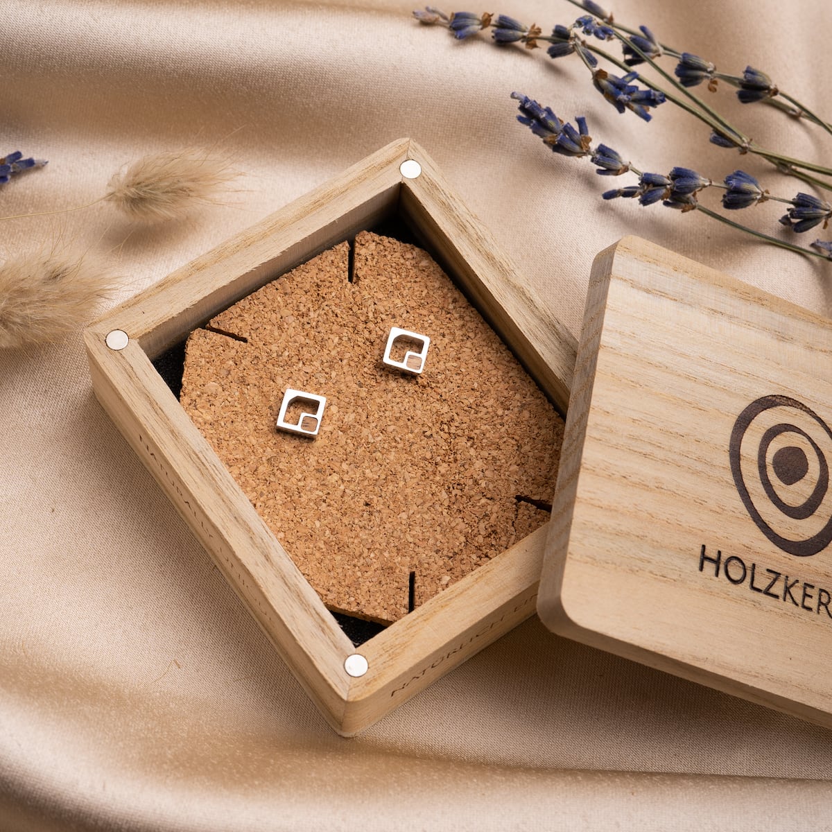 "Geometric Earrings" earrings showcase a sleek geometric design in koa wood and silver, presented in an elegant wooden box.