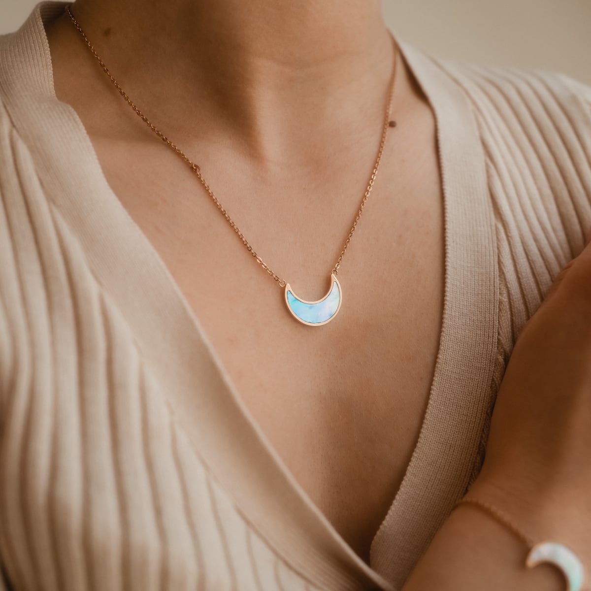 "Hue Necklace": Elegant crescent necklace in blue nacre with rose gold accents.